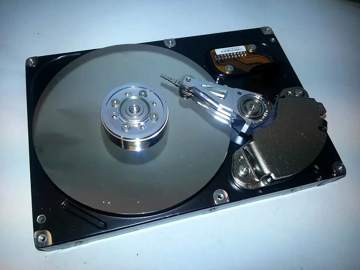Opened hard-disk drive showing platter and head assembly